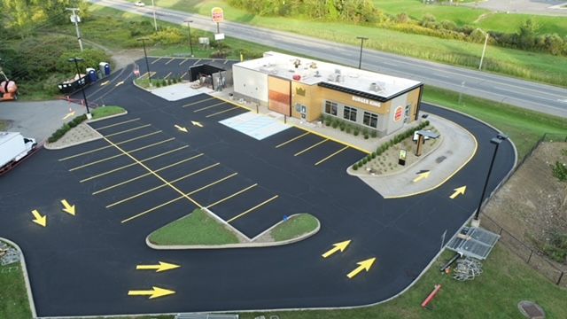 Oblique aerial view of the Burger King property in Gloversville showing the drive-through route and parking layout