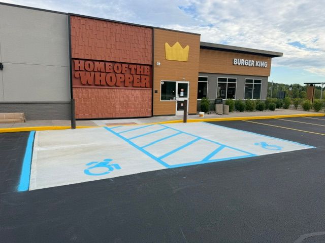 Concrete accessible parking spaces and marked access aisle at the Burger King entrance in Gloversville