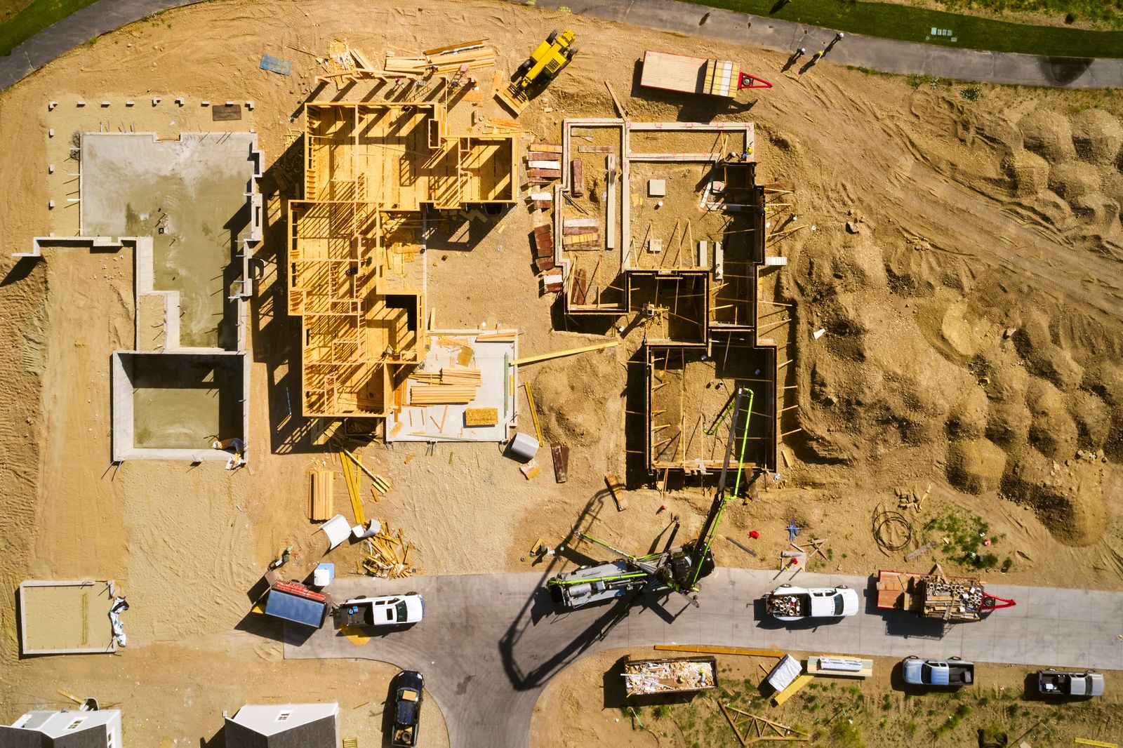 Aerial view of a prepared construction site with foundations and framing