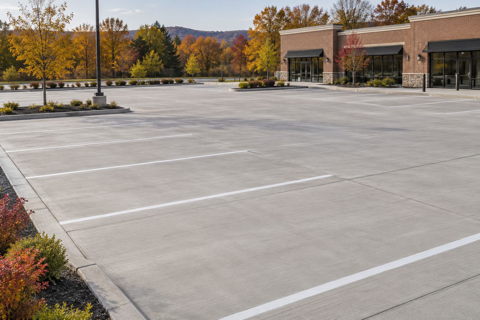 Concrete parking areas, marked spaces and curbs beside a commercial building